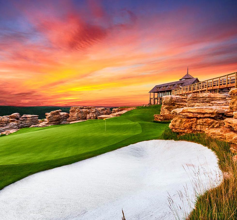 Ozarks golf at Mountain Top short course by Gary Player, featuring a cliffside green, limestone formations, and sunset views in Branson, Missouri