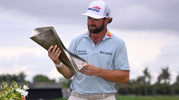 Cameron Young holds the Cadillac Championship trophy after his win at Doral.
