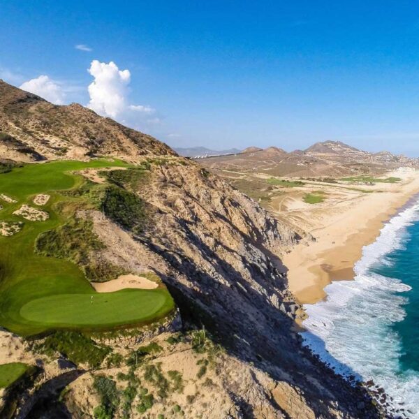 Aerial view of Quivira Golf Club in Los Cabos, showing a dramatic cliffside golf hole overlooking the Pacific Ocean and Baja coastline.